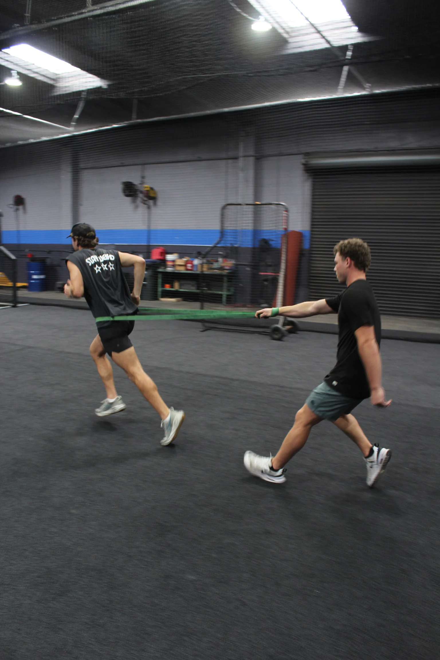 Jarrod Hocking coaching an athlete through a band-resisted sprint at The Body Shop